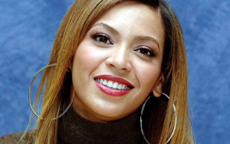 woman with hoop earrings smiling