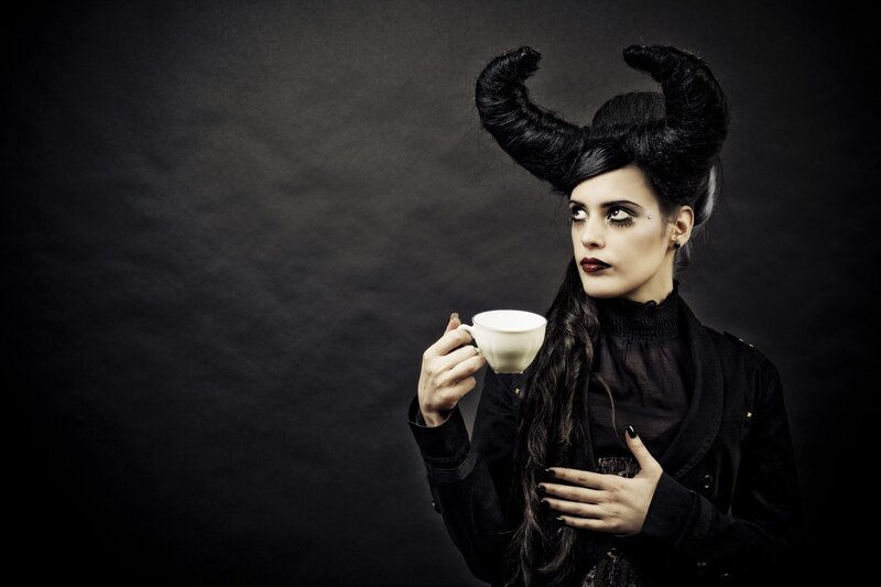 woman with horns holding tea cup