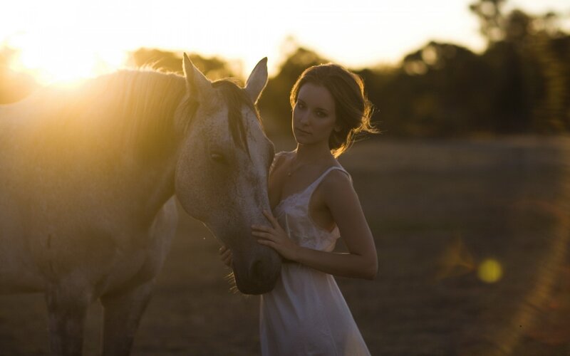 woman with horse at sunset
