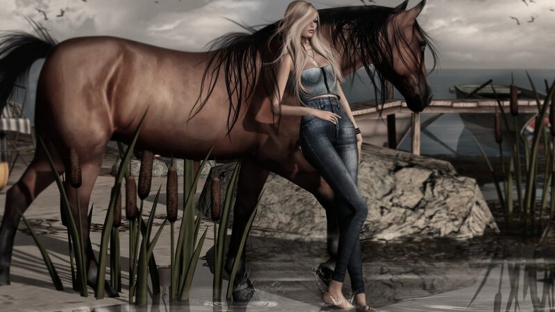 woman with horse by water