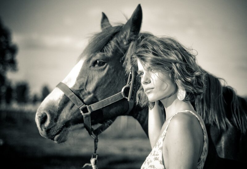 woman with horse in field