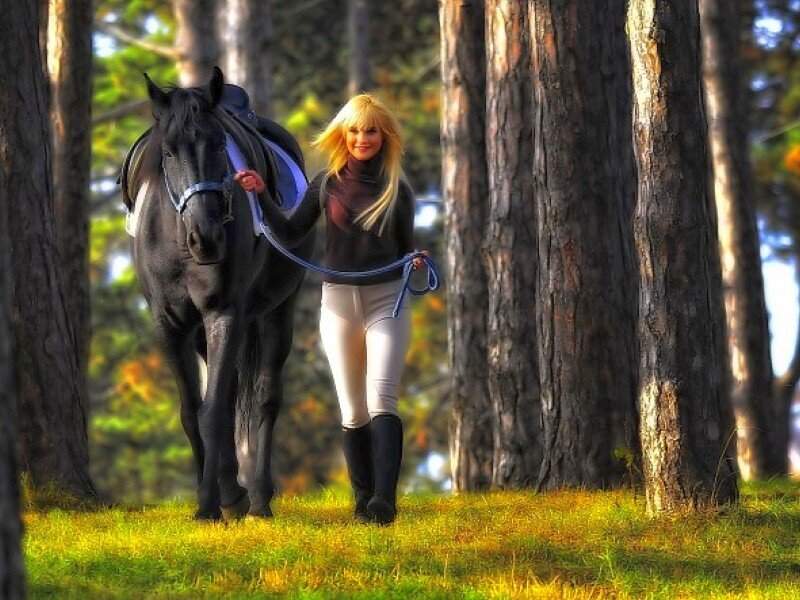 Woman with horse in forest