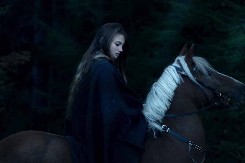 woman with horse in forest