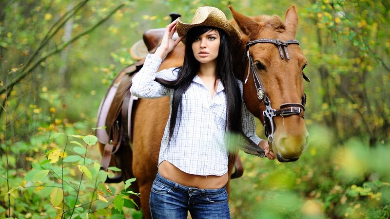 Woman with horse in forest