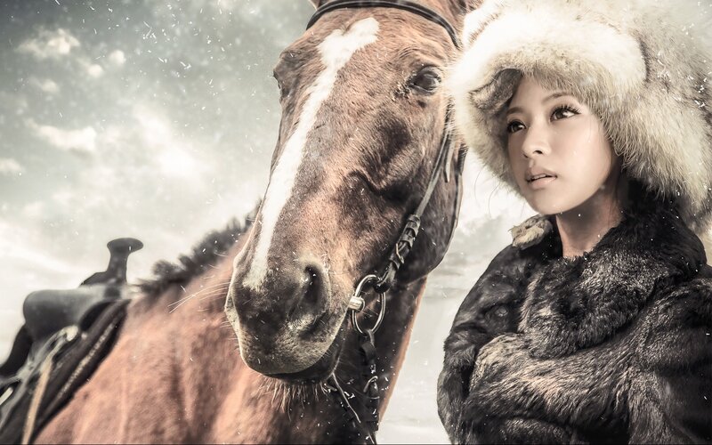 woman with horse in snow
