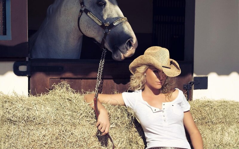 Woman with horse in stable