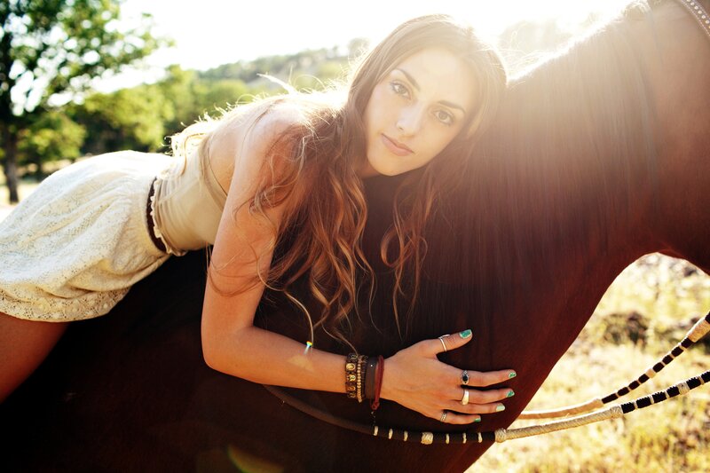 woman with horse in sunlight