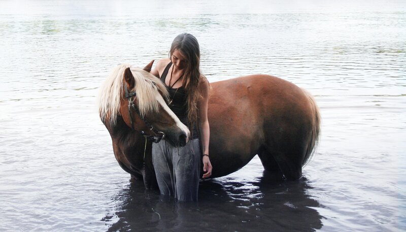 Woman with horse in water