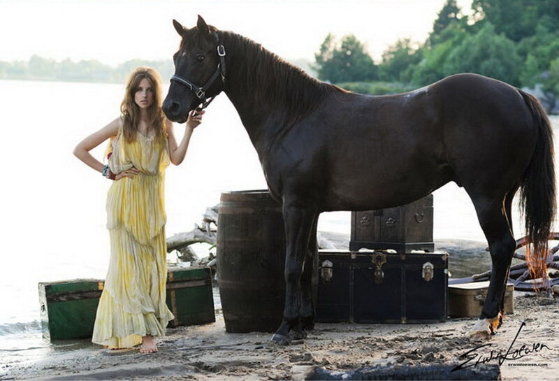 woman with horse on beach