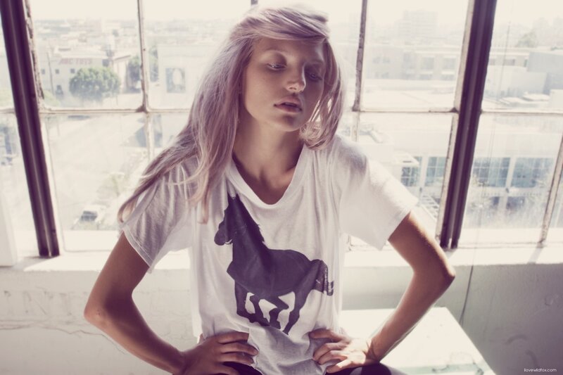 woman with horse t-shirt by window