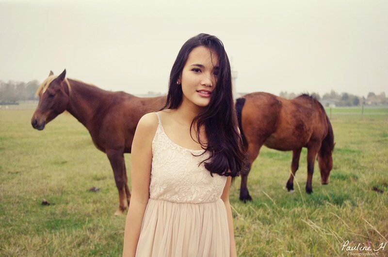 Woman with horses in a field