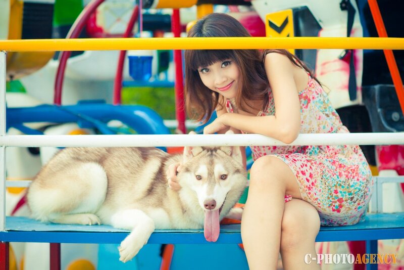 Woman with husky at amusement park