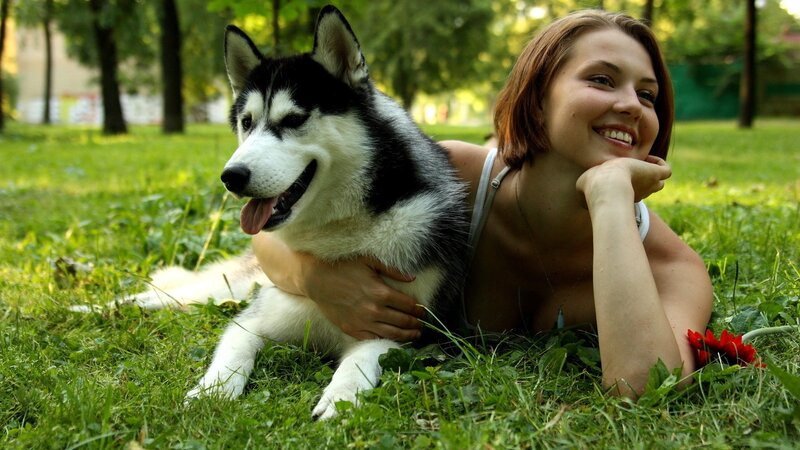 Woman with husky dog in park