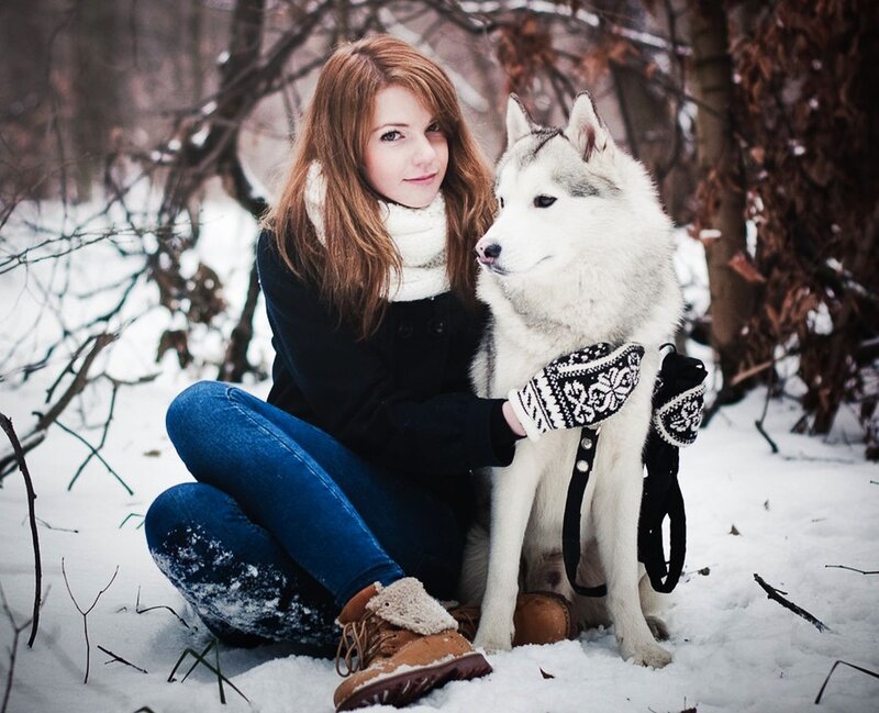 Woman with husky in snow