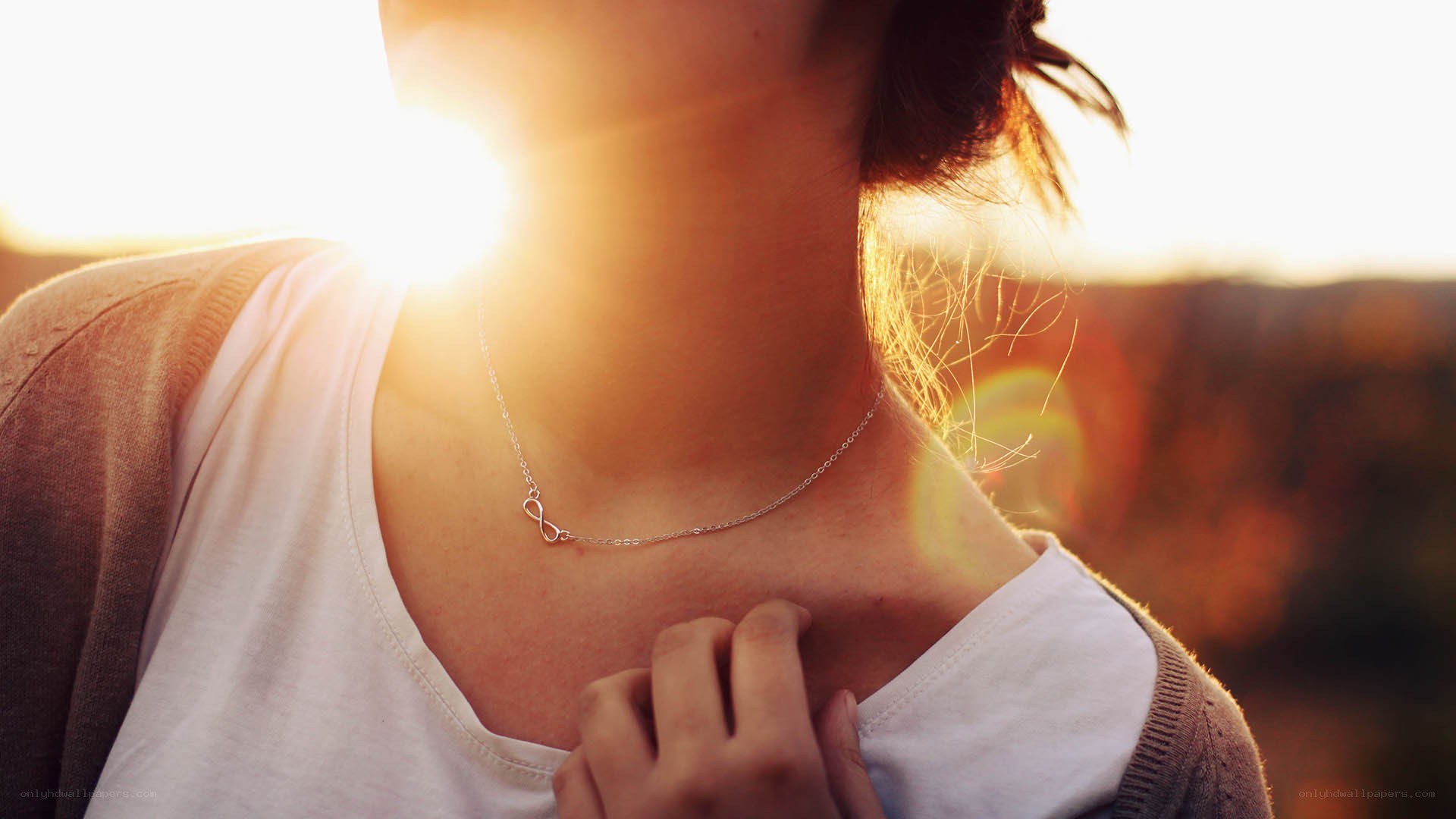 woman with infinity necklace at sunset