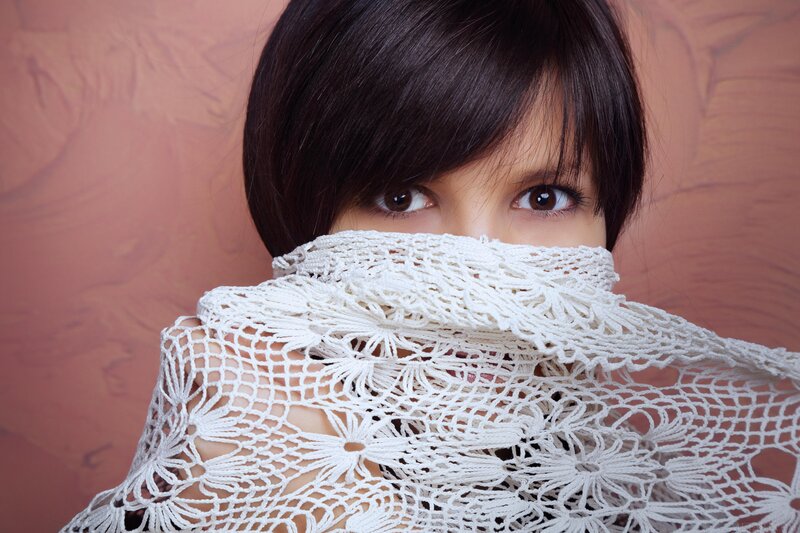 woman with lace covering face