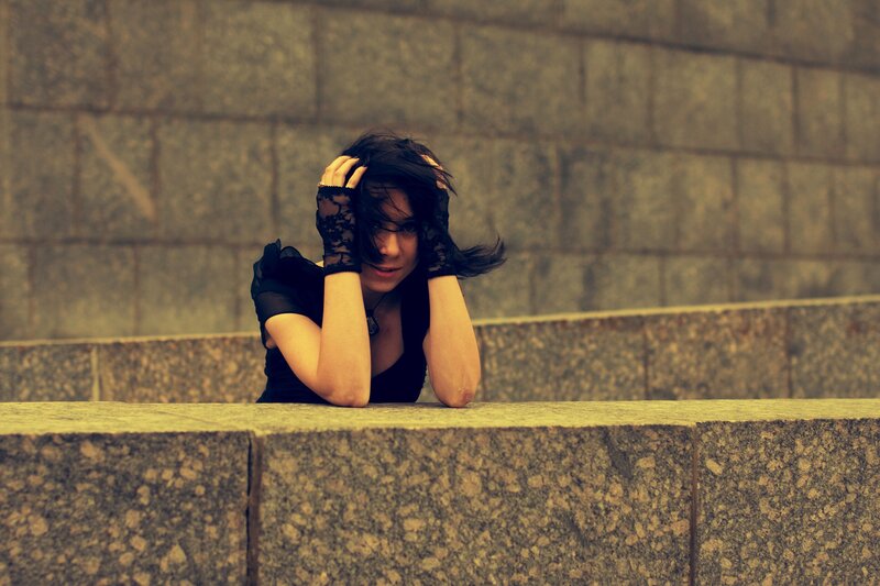 woman with lace gloves on stone