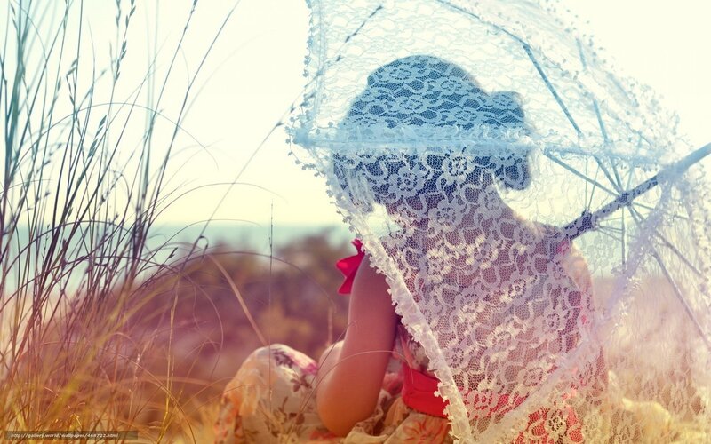 woman with lace parasol in field