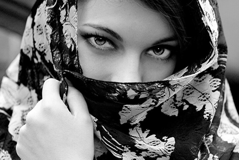 woman with lace scarf covering face