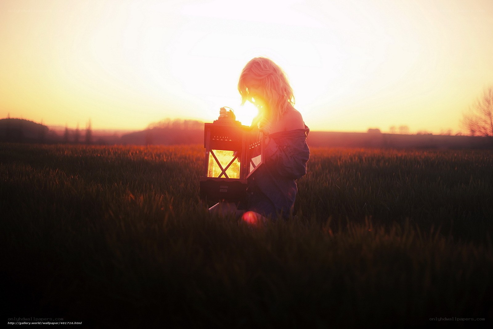 woman with lantern at sunset