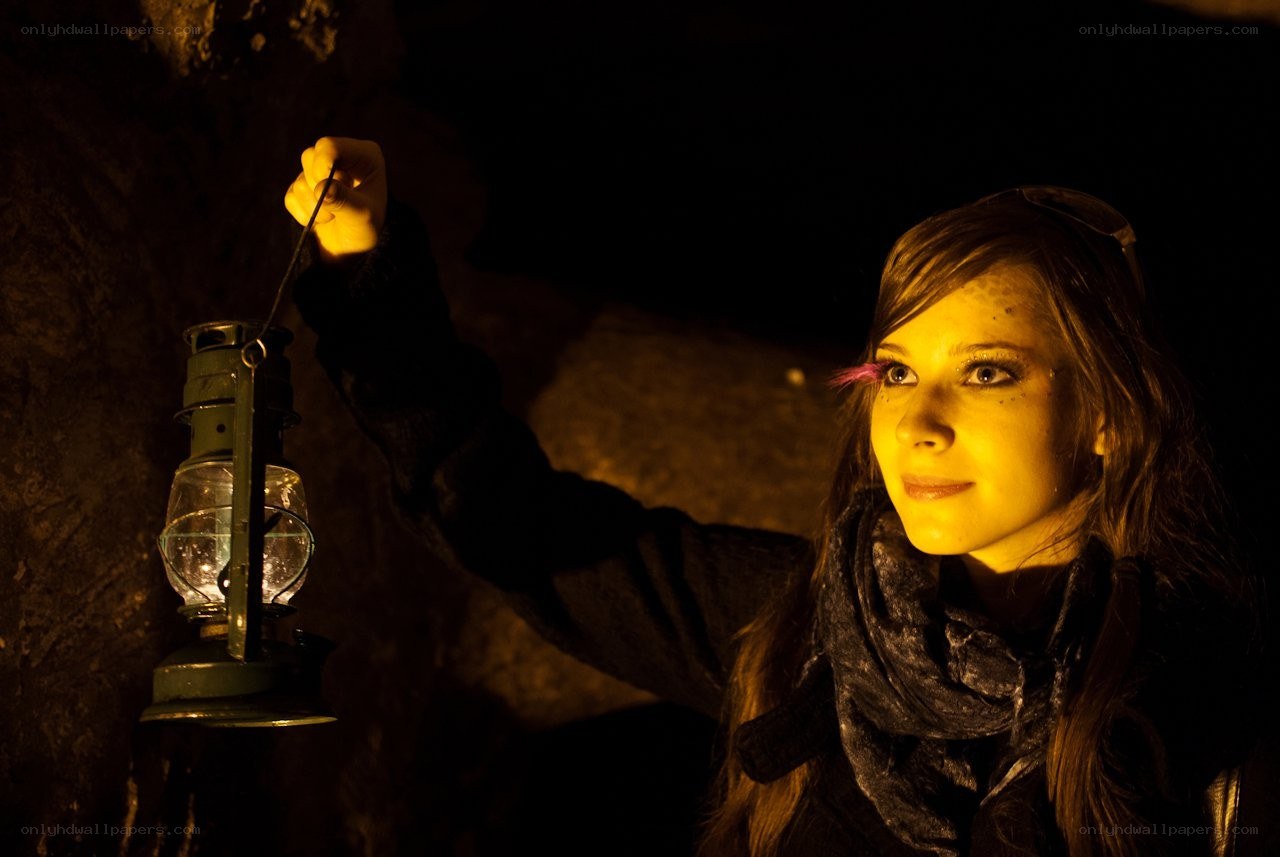 woman with lantern in cave