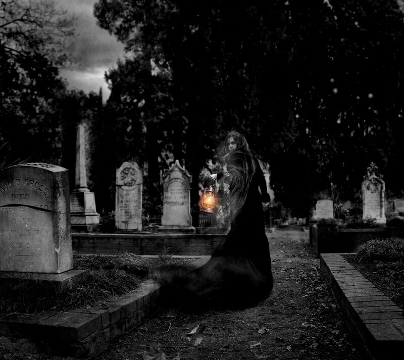 Woman with Lantern in Cemetery
