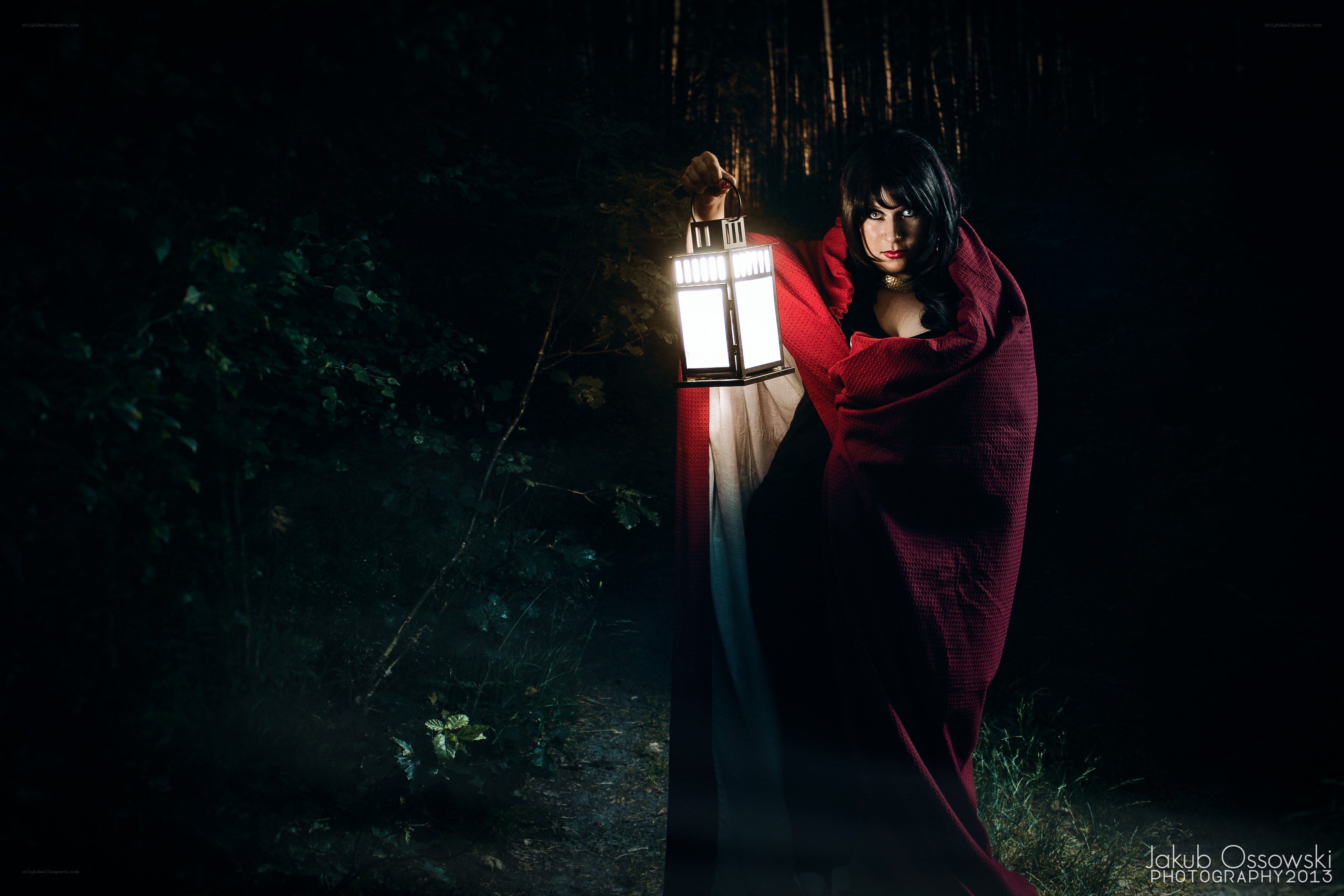 Woman with lantern in forest