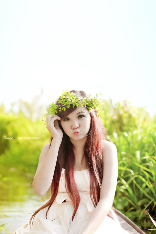woman with leaf crown in boat