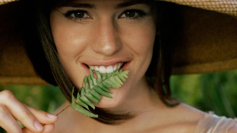 woman with leaf in mouth