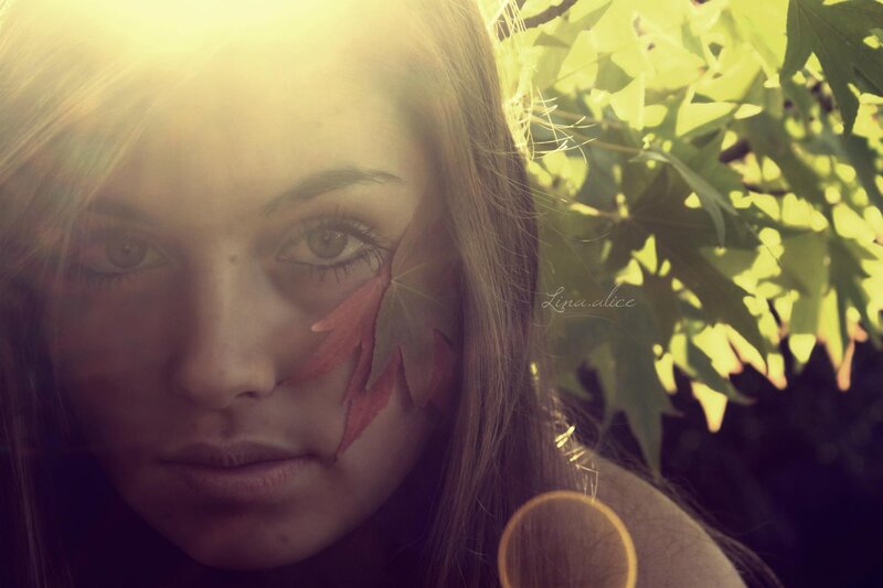 woman with leaf on face