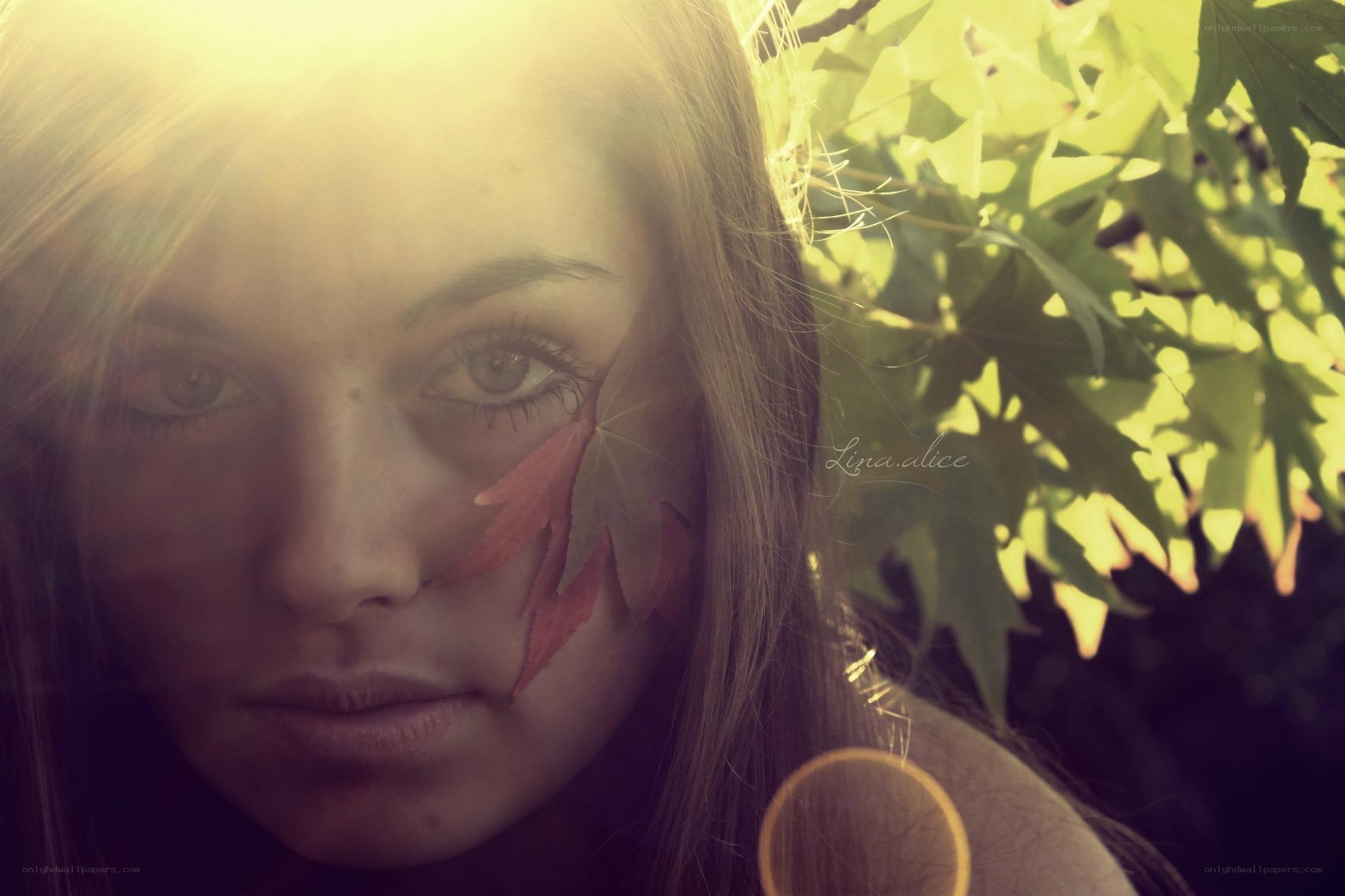 woman with leaf on face