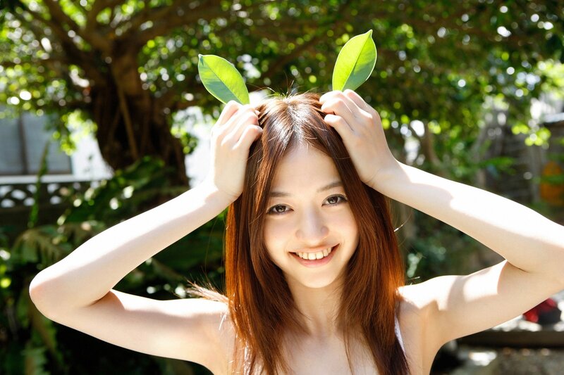 Woman with leaves on head