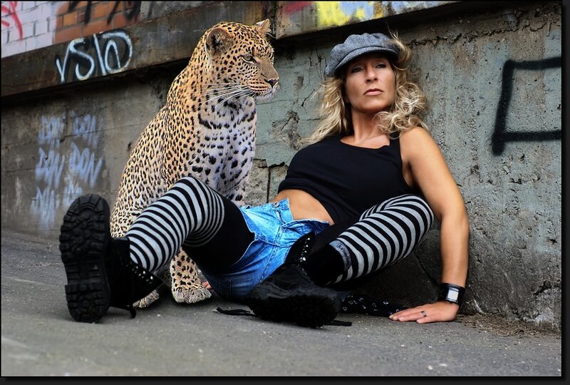 Woman with leopard in urban setting