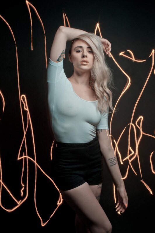 woman with light hair and tattoos