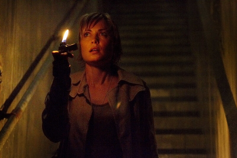 Woman with lighter in dark stairwell