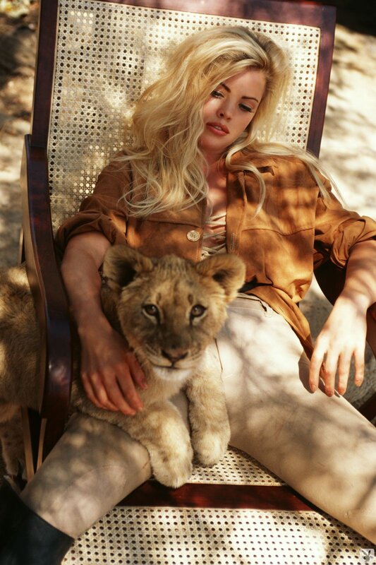 Woman with lion cub on chair