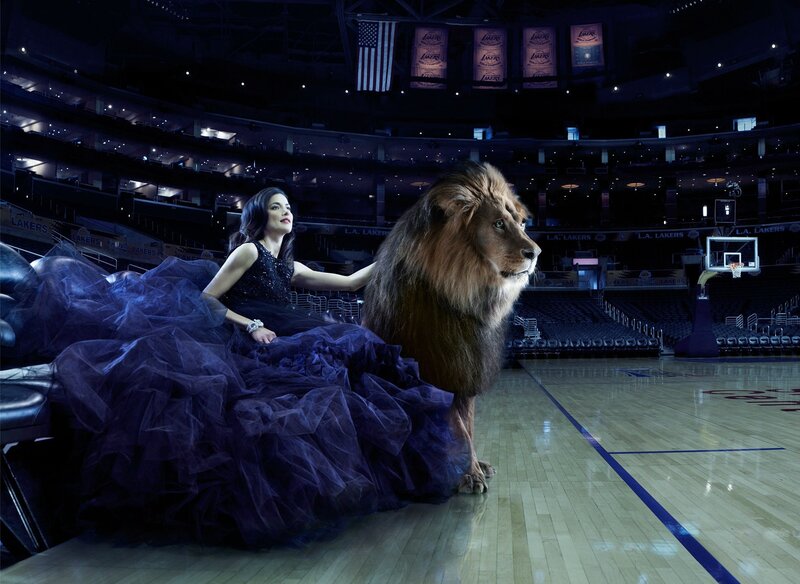 Woman with lion in basketball arena