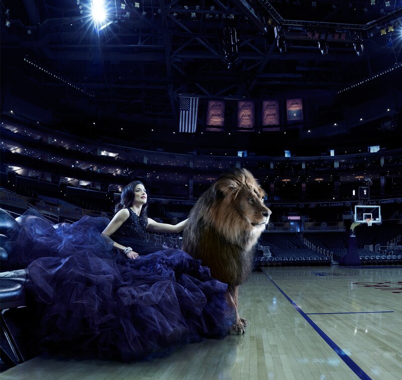 Woman with lion on basketball court