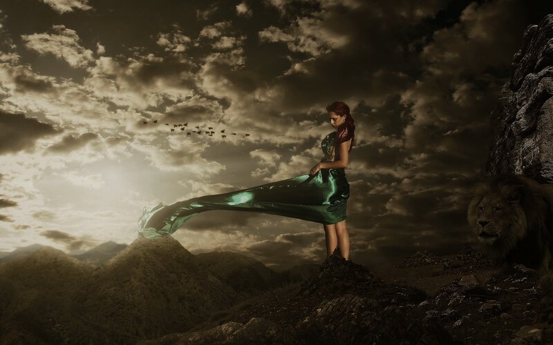Woman with lion on mountain