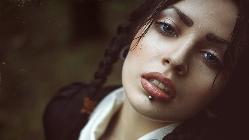woman with lip piercing in forest
