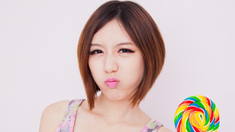 woman with lollipop making a face