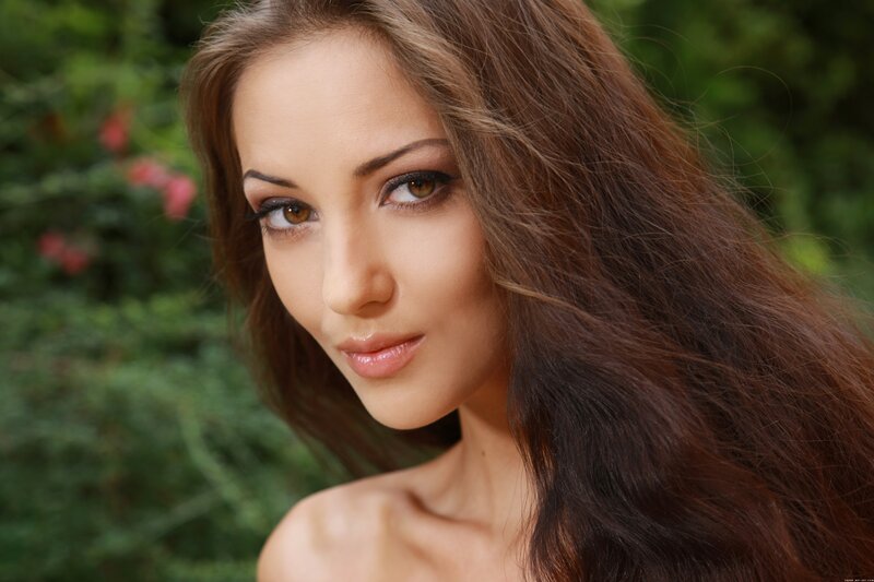 Woman with Long Brown Hair — Calm, Afternoon, Photograph, Green Foliage, Flowers