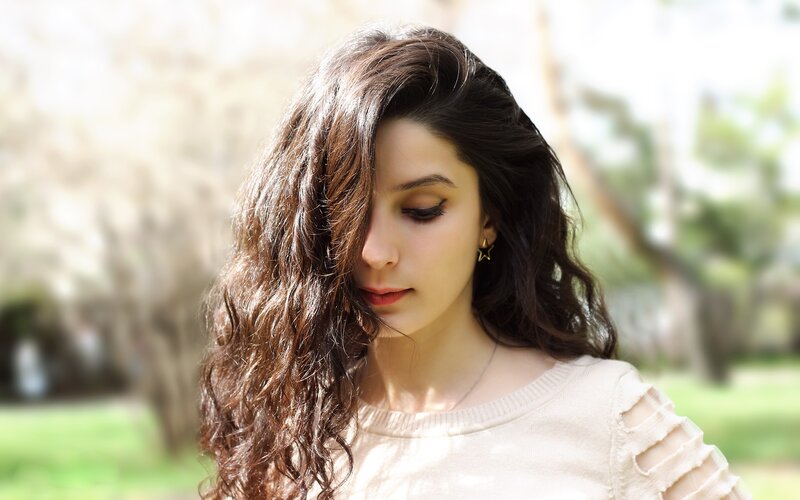 Woman with Long Brown Hair — Serene, Afternoon, Photograph, Earring, Sweater