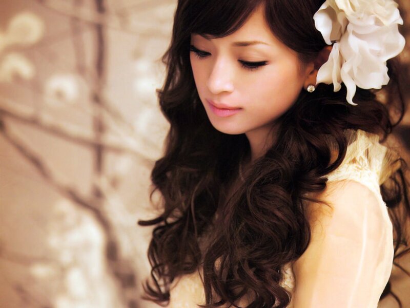 Woman with Long Dark Hair — Brown, Serene, Photograph, White Flower
