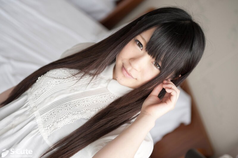 woman with long dark hair in white dress