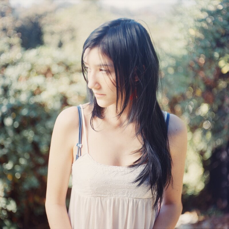 Woman with Long Dark Hair — White, Serene, Afternoon