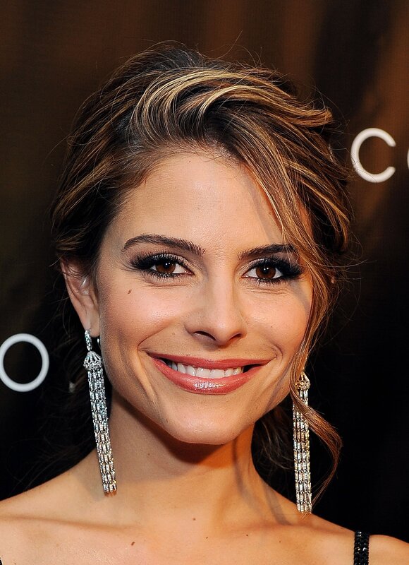 woman with long earrings smiling