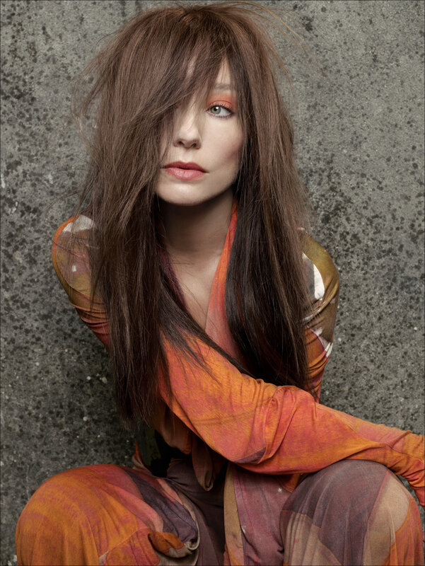 woman with long hair and colorful outfit