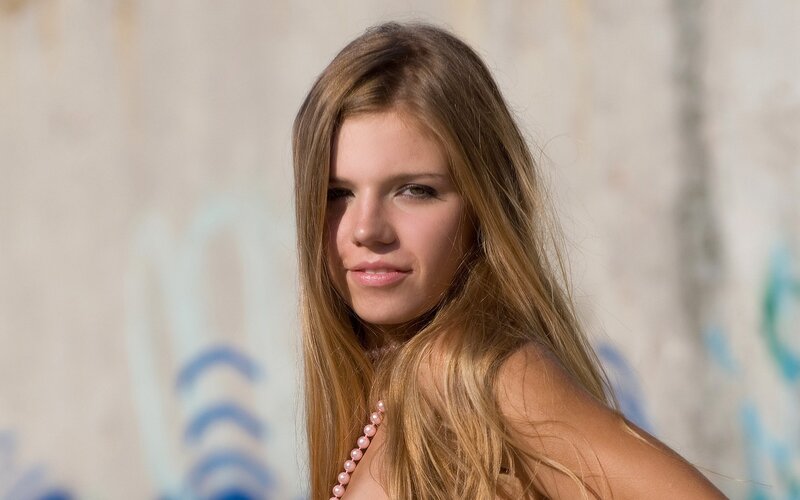 woman with long hair and pearl necklace