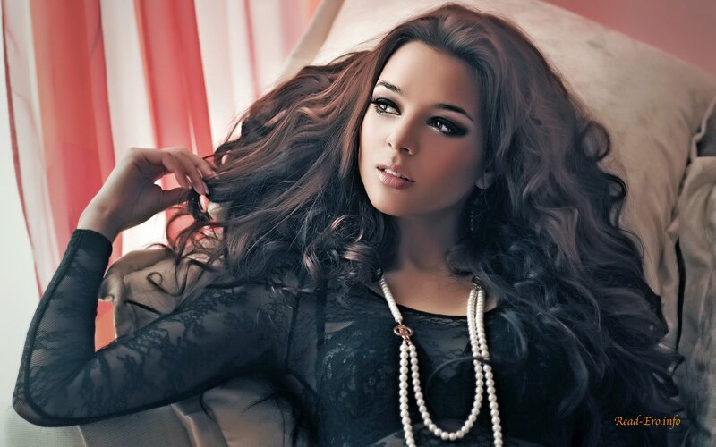 woman with long hair and pearls